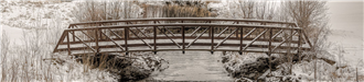 Bassett Creek bridge in the winter with snow covering it