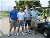 Four Golfers Beside a Golf Cart