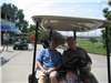 Two Golfers Sit in a Golf Cart Together