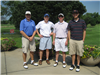 Four Golfers Pose Beside Planters