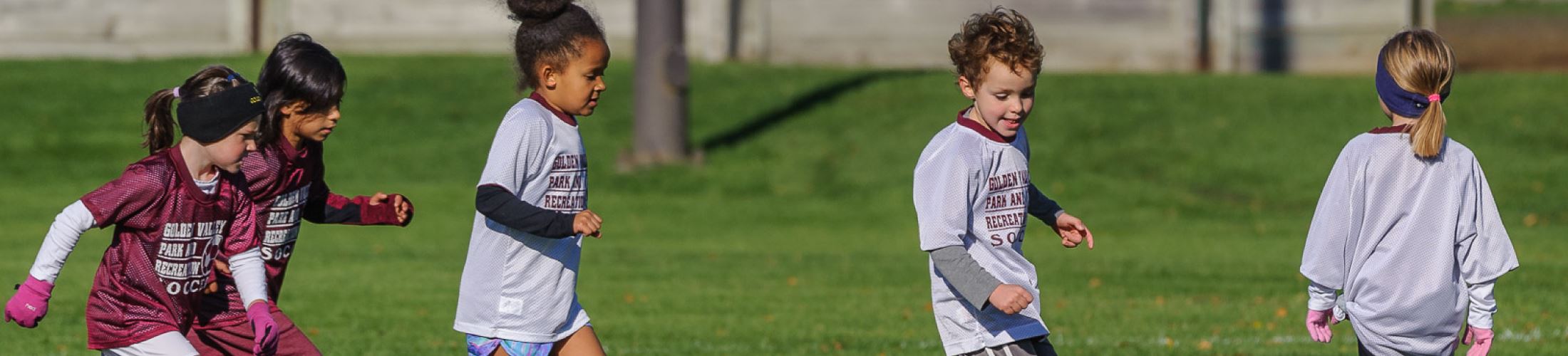 Group of young kids playing soccer