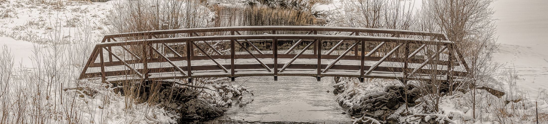 Bassett Creek bridge in the winter with snow covering it