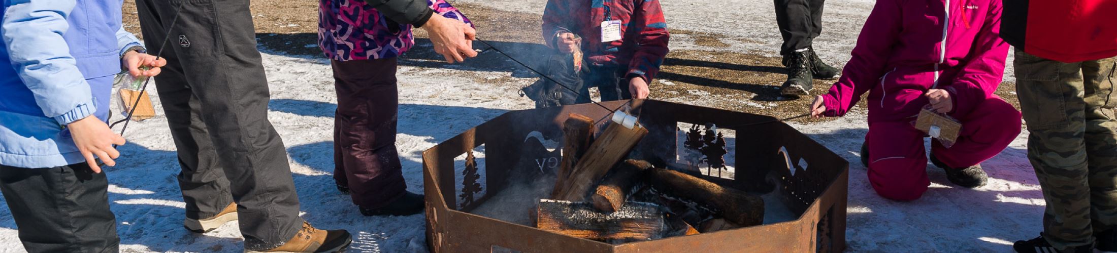 group of people around a fire pit during the winter