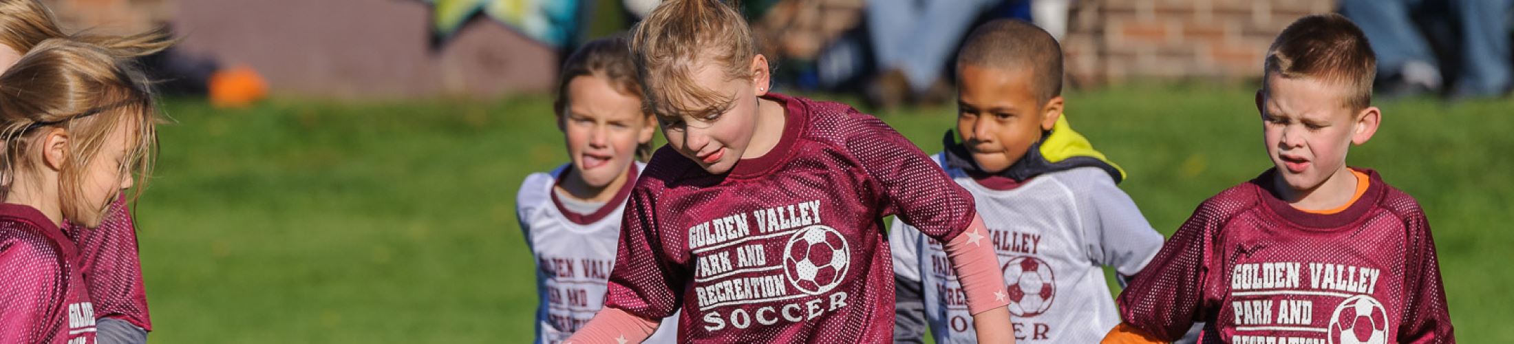 group of kids playing soccer