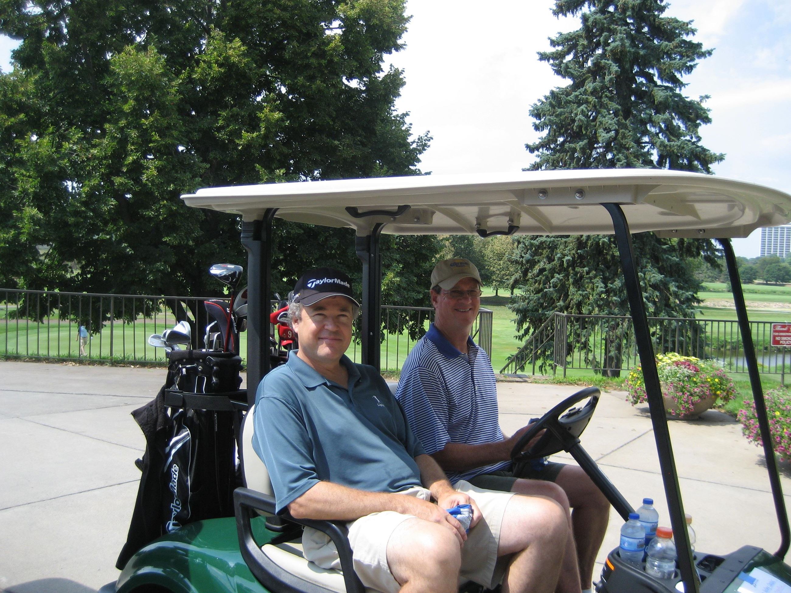 Two Golfers Share a Golf Cart
