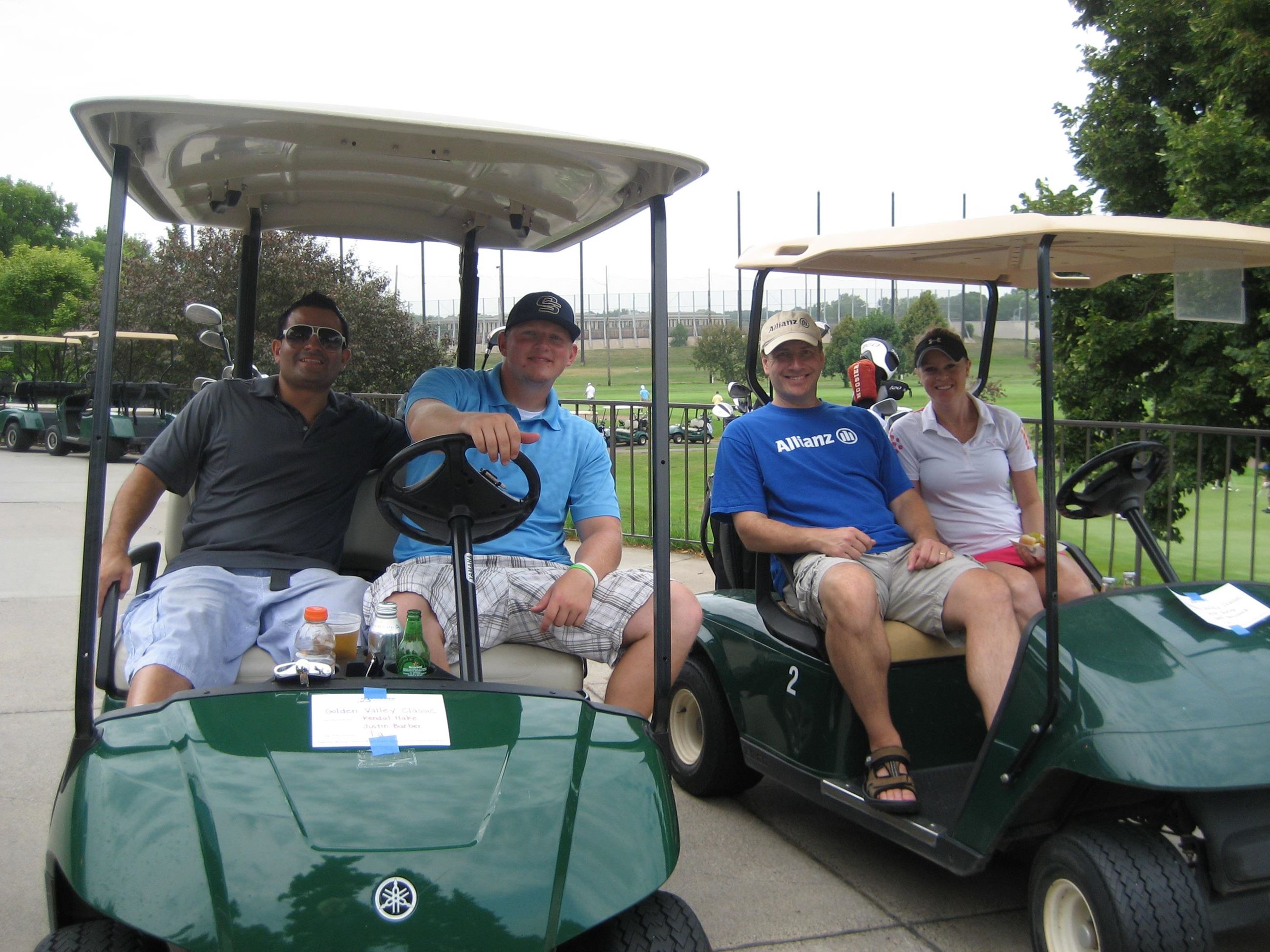Two Golf Carts with Two Riders on Each
